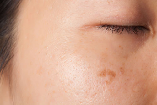 closeup of woman's face with her eyes closed